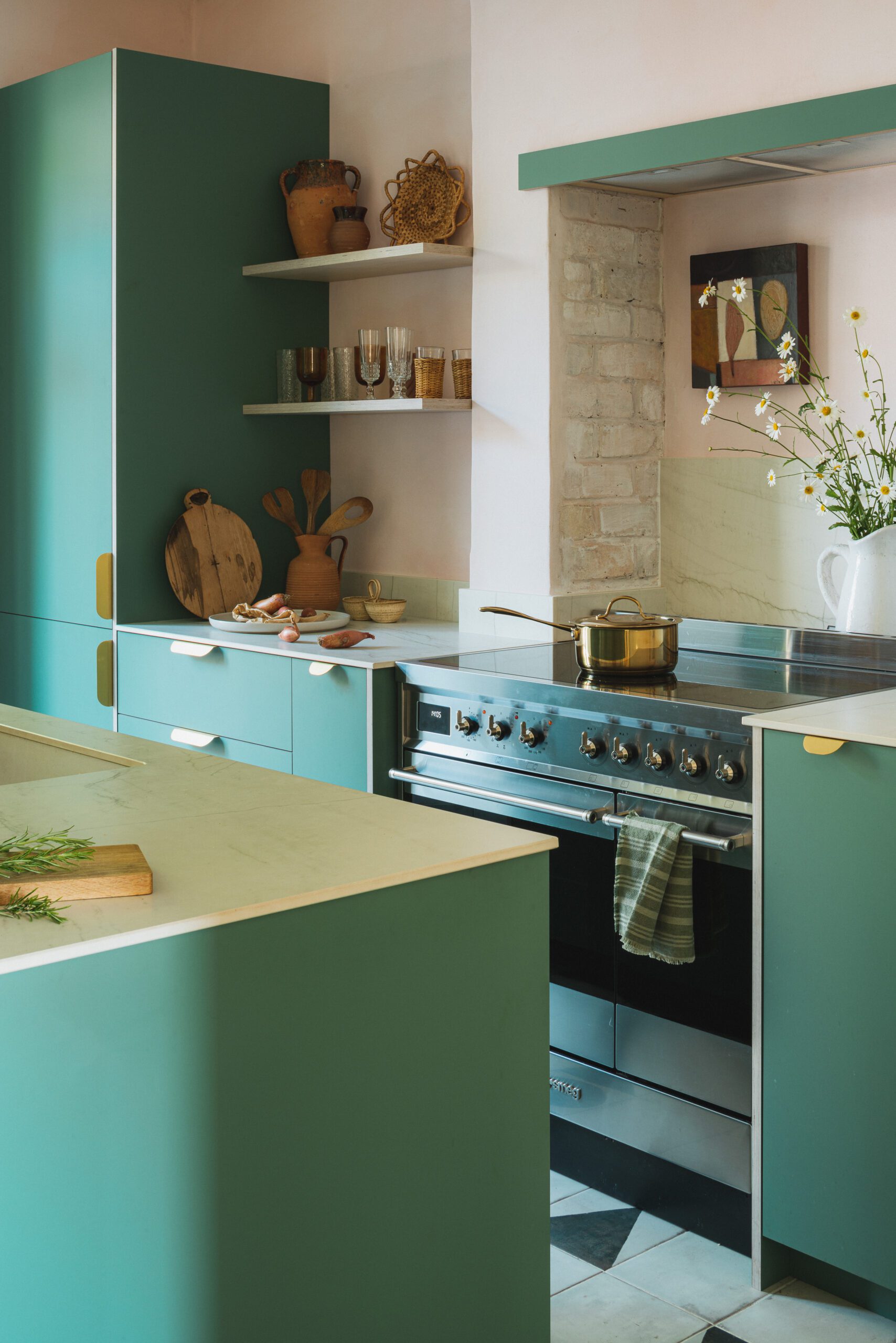 Made by HUSK's Goldney Lodge Kitchen, featuring green kitchen fronts and white/grey worktops.