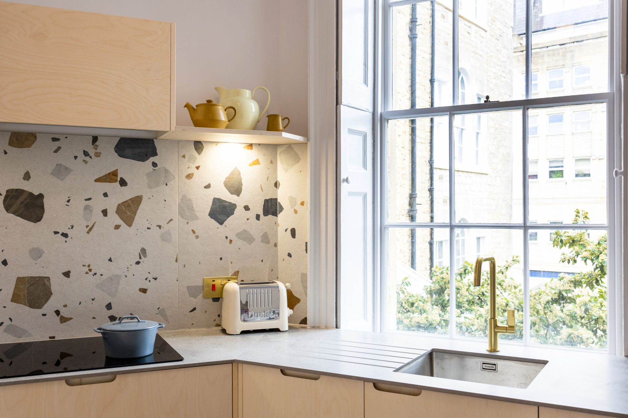 Husk's Writers Retreat Kitchen, which features plywood kitchen fronts and terrazzo tiling.