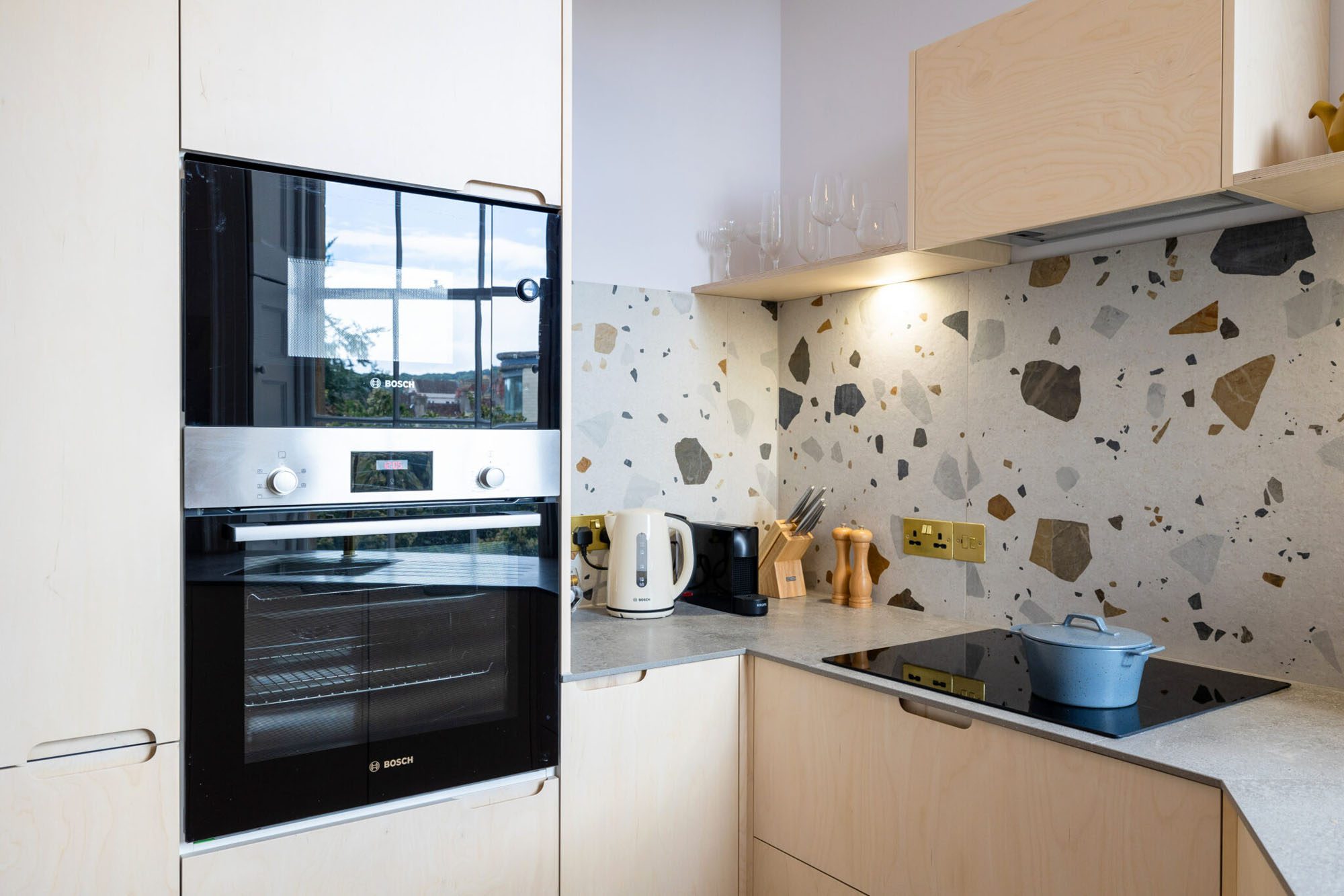Husk's Writers Retreat Kitchen, which features plywood kitchen fronts and terrazzo tiling.