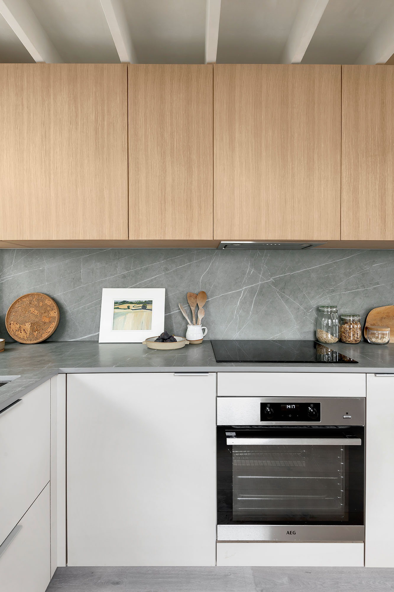 Husk's Old Pottery Kitchen, featuring Natura HPL Grigio Viola fronts and grey marble worktops.
