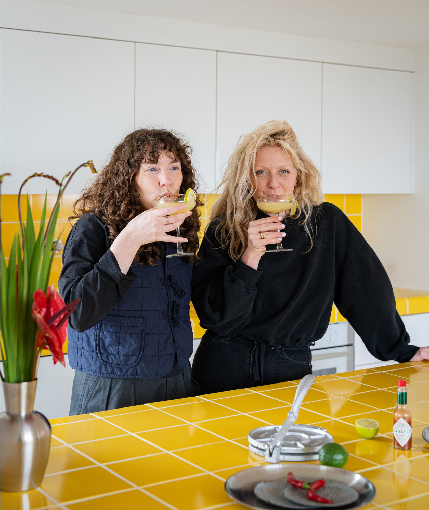 HUSK's Kitchen Designers Georgia and Freya in the Yellow and White Westmoreland Road Kitchen featuring FENIX Bianco Kos Fronts