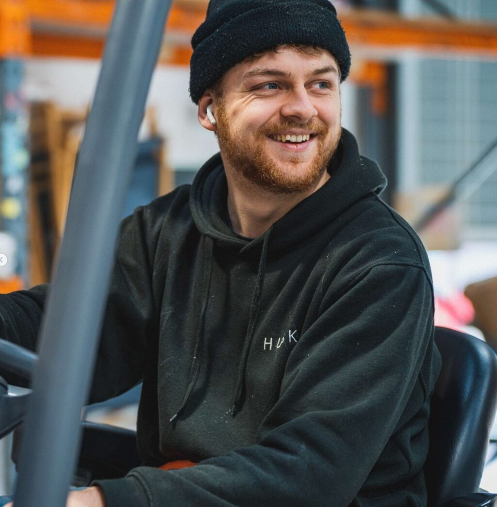 Happy kitchen maker driving a forklift