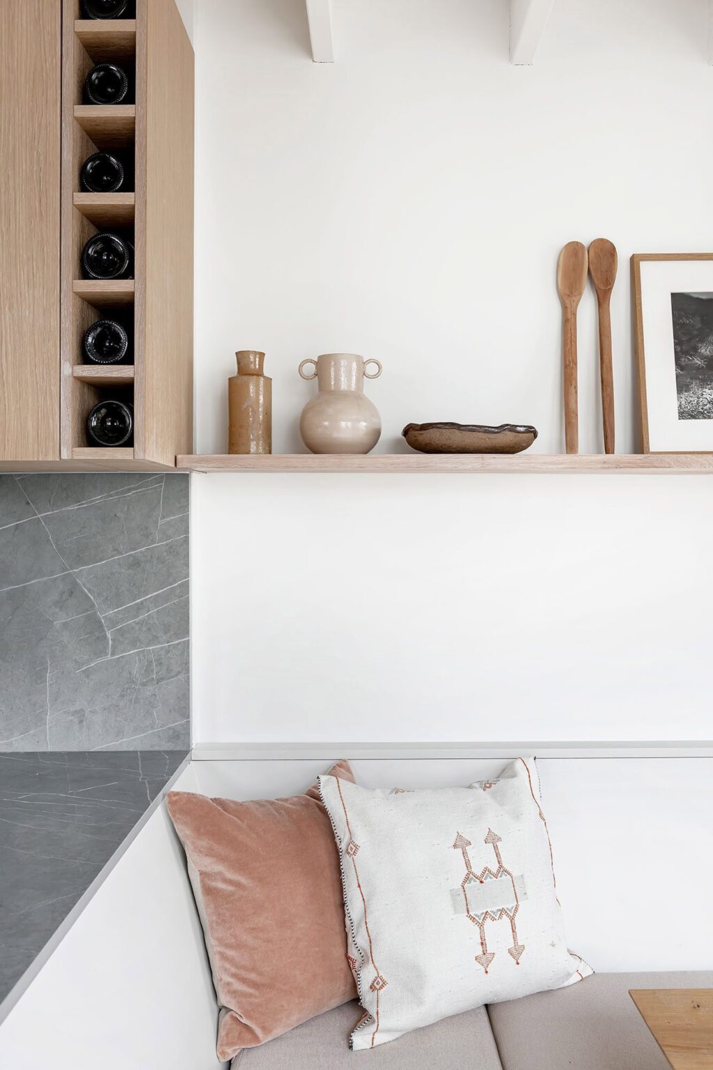 Snapshot of smart space-saving kitchen details including wine storage, integrated banquette seating and open shelving for displaying decorative items