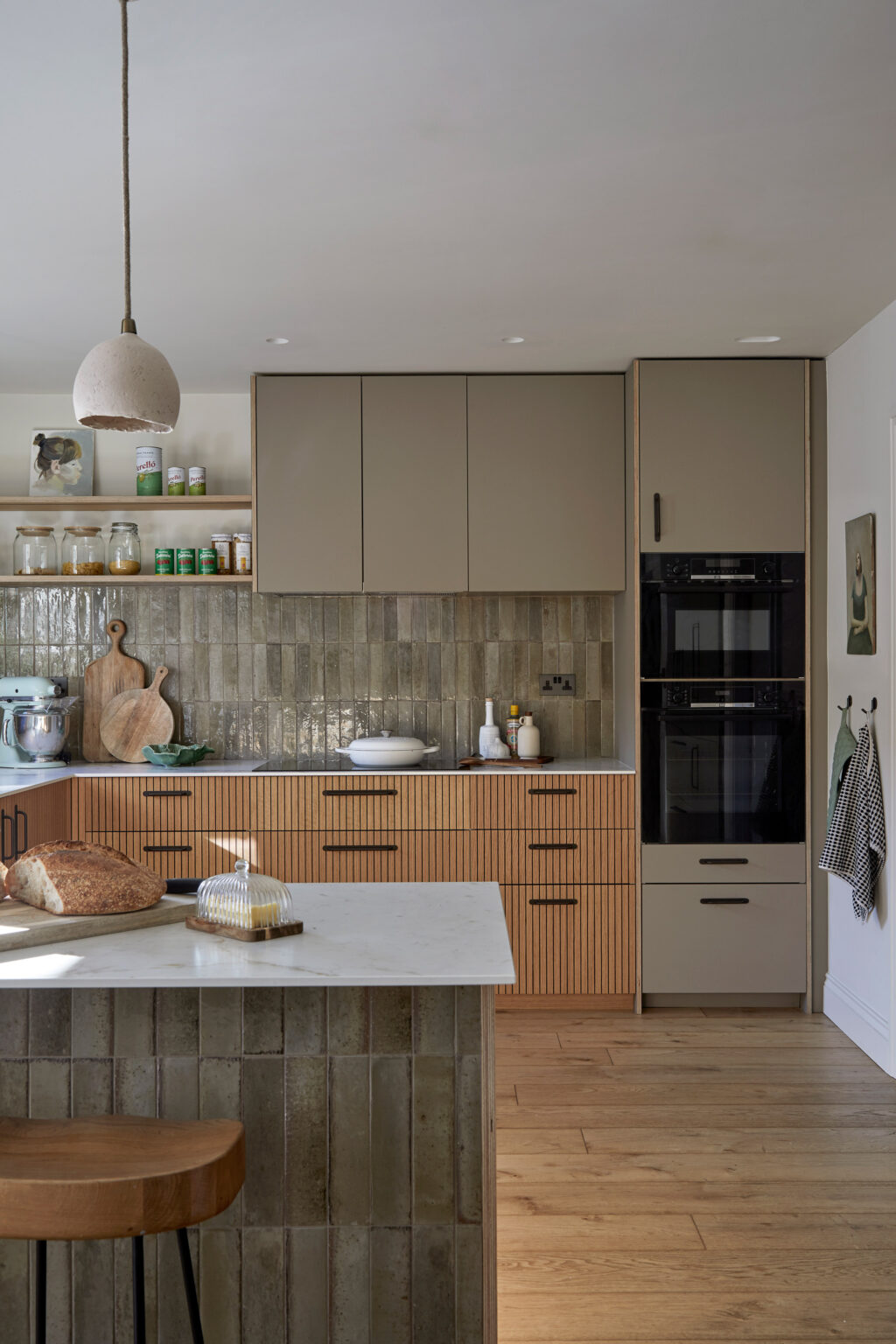 An earthy green U-shaped kitchen designed by HUSK using IKEA cabinetry - featuring kitchen fronts in FENIX® Castoro Ottawa kitchen with Ply Edge and Oak V-Groove kitchen fronts.