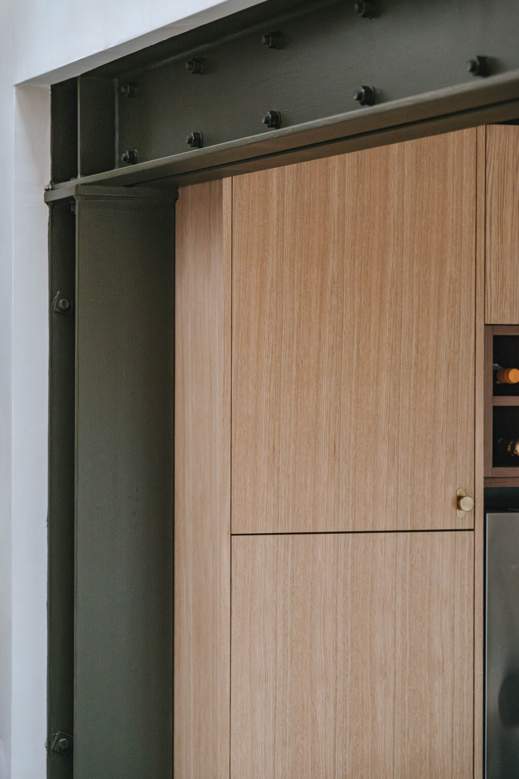 A green RSJ with a modern, oak kitchen doors in the background.