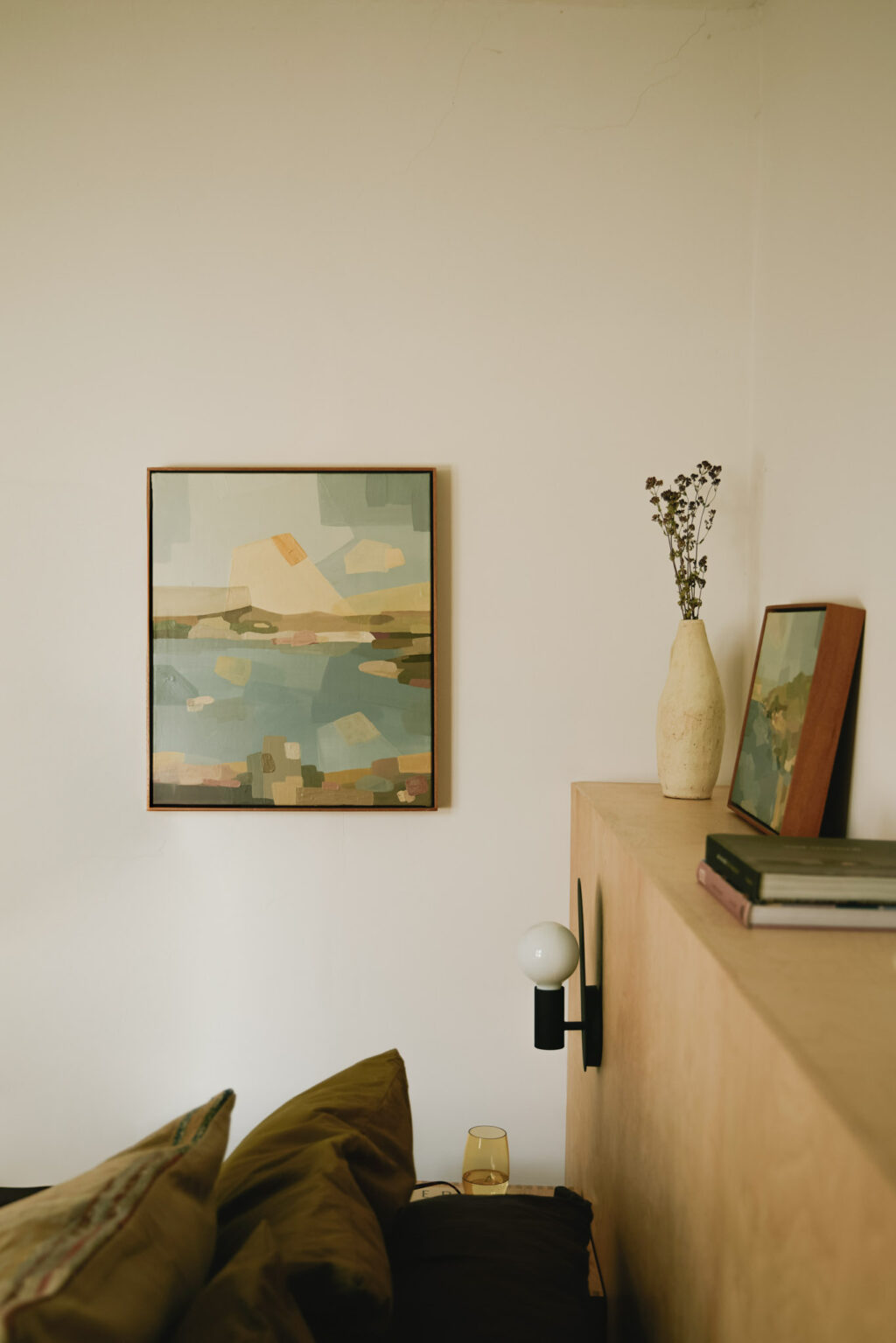 Home interior wall with a framed painting depicting an abstract landscape by Rosa Roig-Fiol