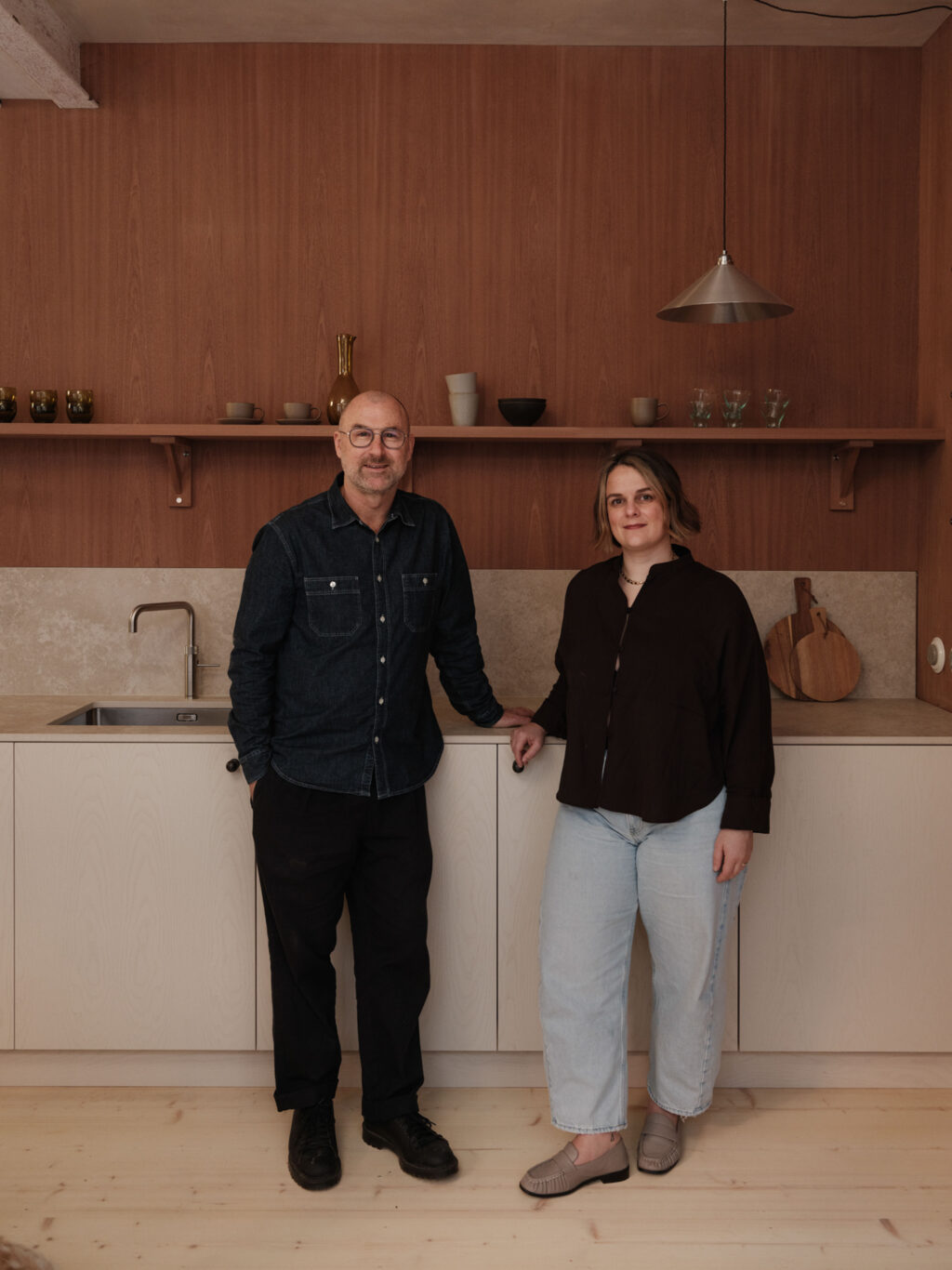 Dave Young & Rosa Roig-Fiol standing in front of a kitchen run from HUSK's new range of kitchen fronts made in collaboration with Ro Projects