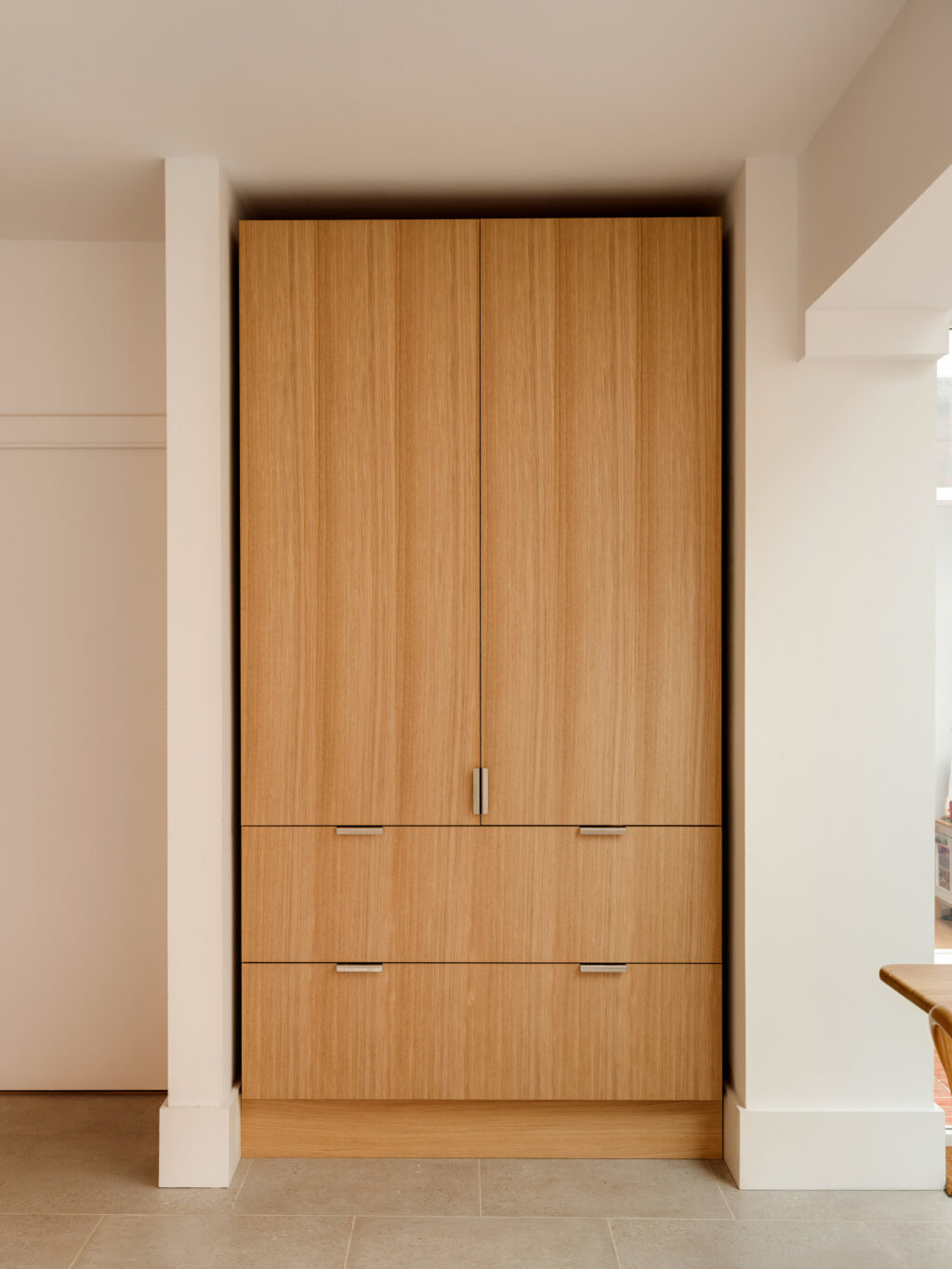 Custom made kitchen pantry in natural oak with minimal stainless steel handles