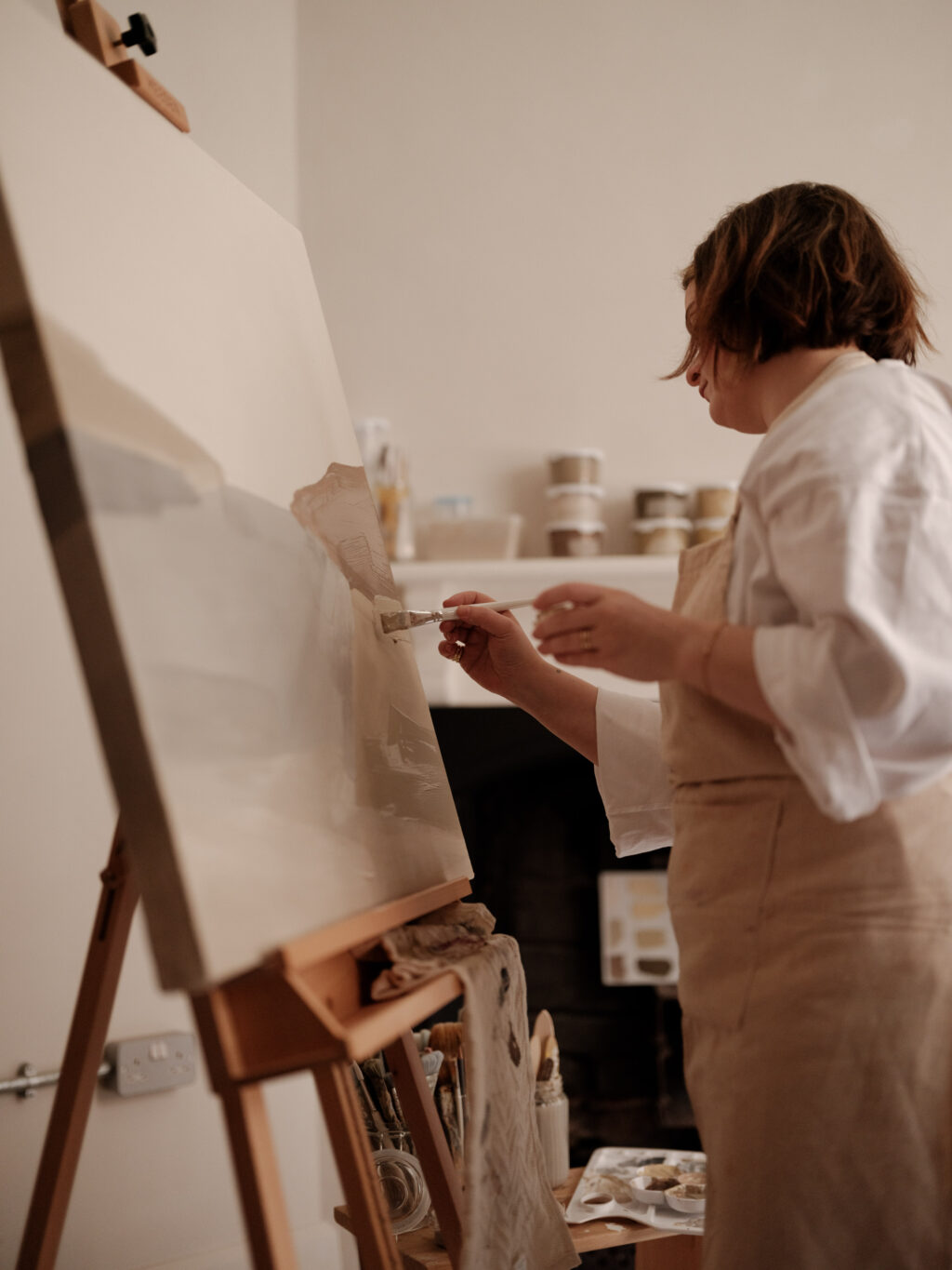 Artist Rosa Roig-Fiol painting an abstract landscape at her easel