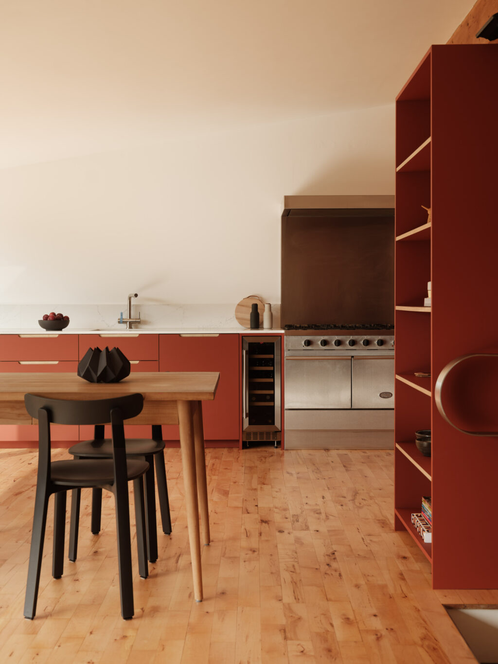 Kitchen corner with stainless steel range cooker, wine fridge, and terracotta cabinetry beside open shelving.