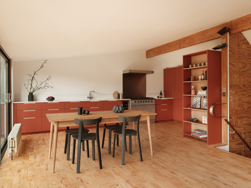 Open-plan kitchen with dining table, black chairs, terracotta cabinetry, and tall open shelving unit.