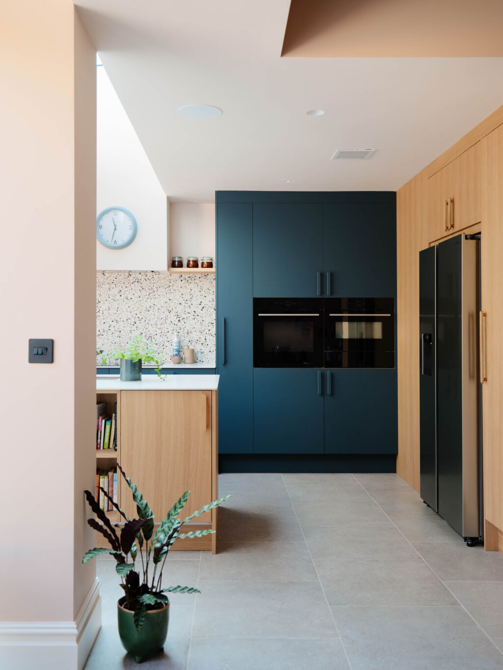 FENIX Blu Shaba tall cabinetry with integrated appliances, oak island and Neolith worktops