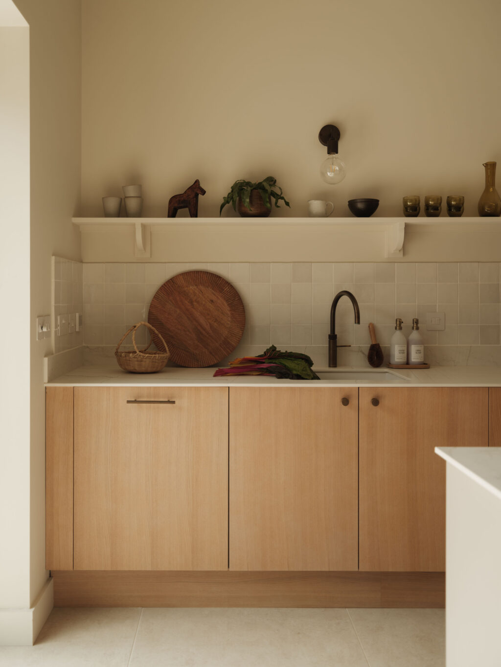 White Tint Oak timber veneer kitchen cabinets with Plank Hardware handles, Neolith Mont Blanc worktop, Quooker tap and tiled splashback in The Gloucestershire House.