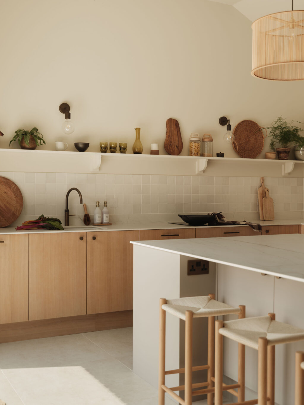 Contemporary kitchen with White Tint Oak timber veneer cabinets, FENIX Beige Arizona island, Neolith Mont Blanc worktops and open shelving in The Gloucestershire House.