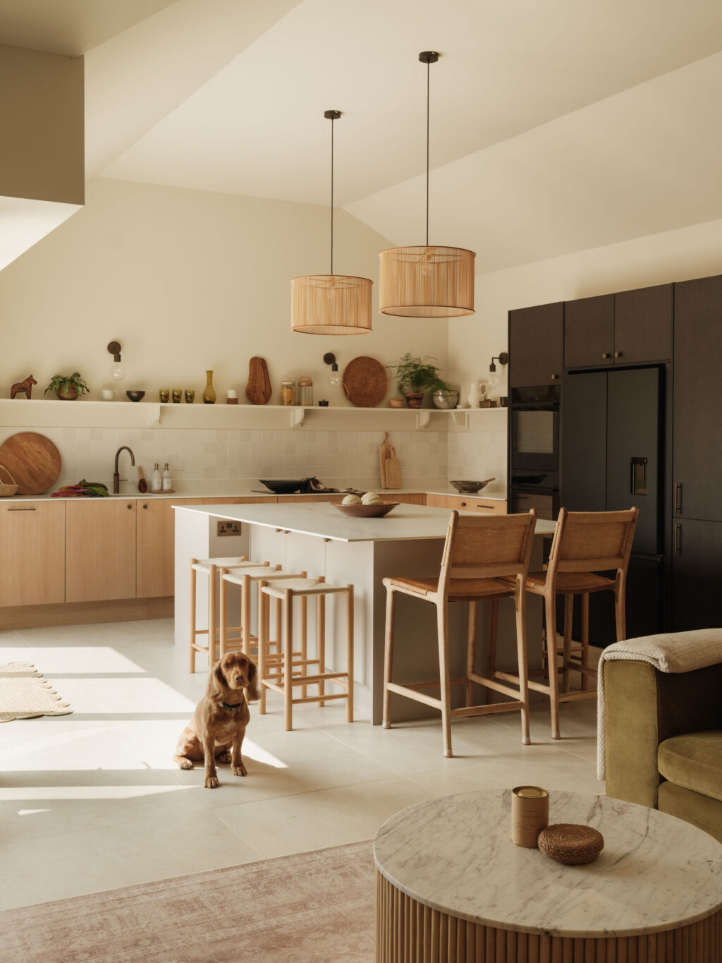 Open-plan kitchen featuring White Tint Oak timber veneer cabinetry, smoked oak tall cabinets, FENIX Beige Arizona island and Neolith Mont Blanc worktops.