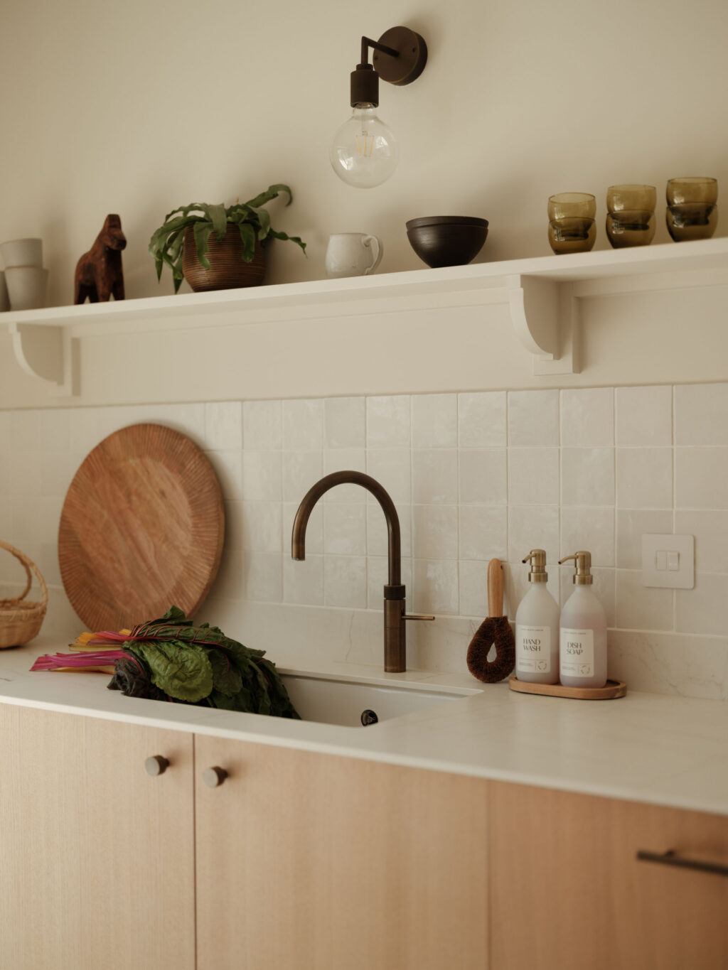 Quooker tap and integrated sink set within a Neolith Mont Blanc worktop, paired with White Tint Oak timber veneer cabinetry and handcrafted open shelving.