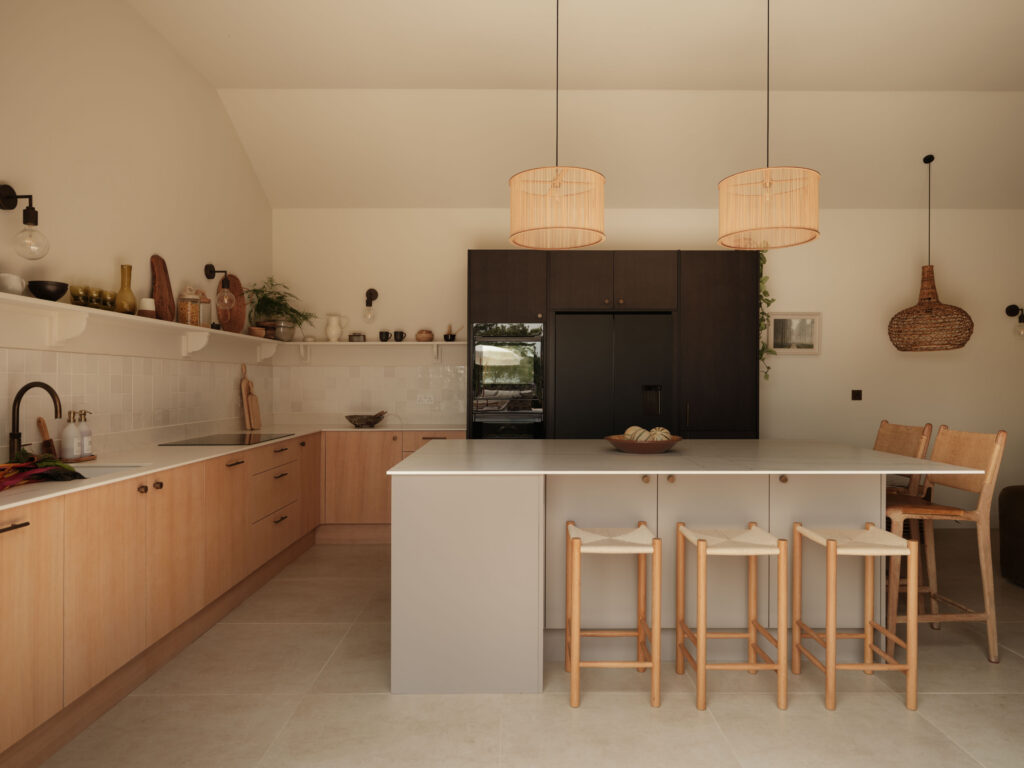 Open-plan kitchen with FENIX Beige Arizona island, White Tint Oak timber veneer cabinetry, smoked oak tall cabinets, Neolith Mont Blanc worktops and Fisher & Paykel appliances.