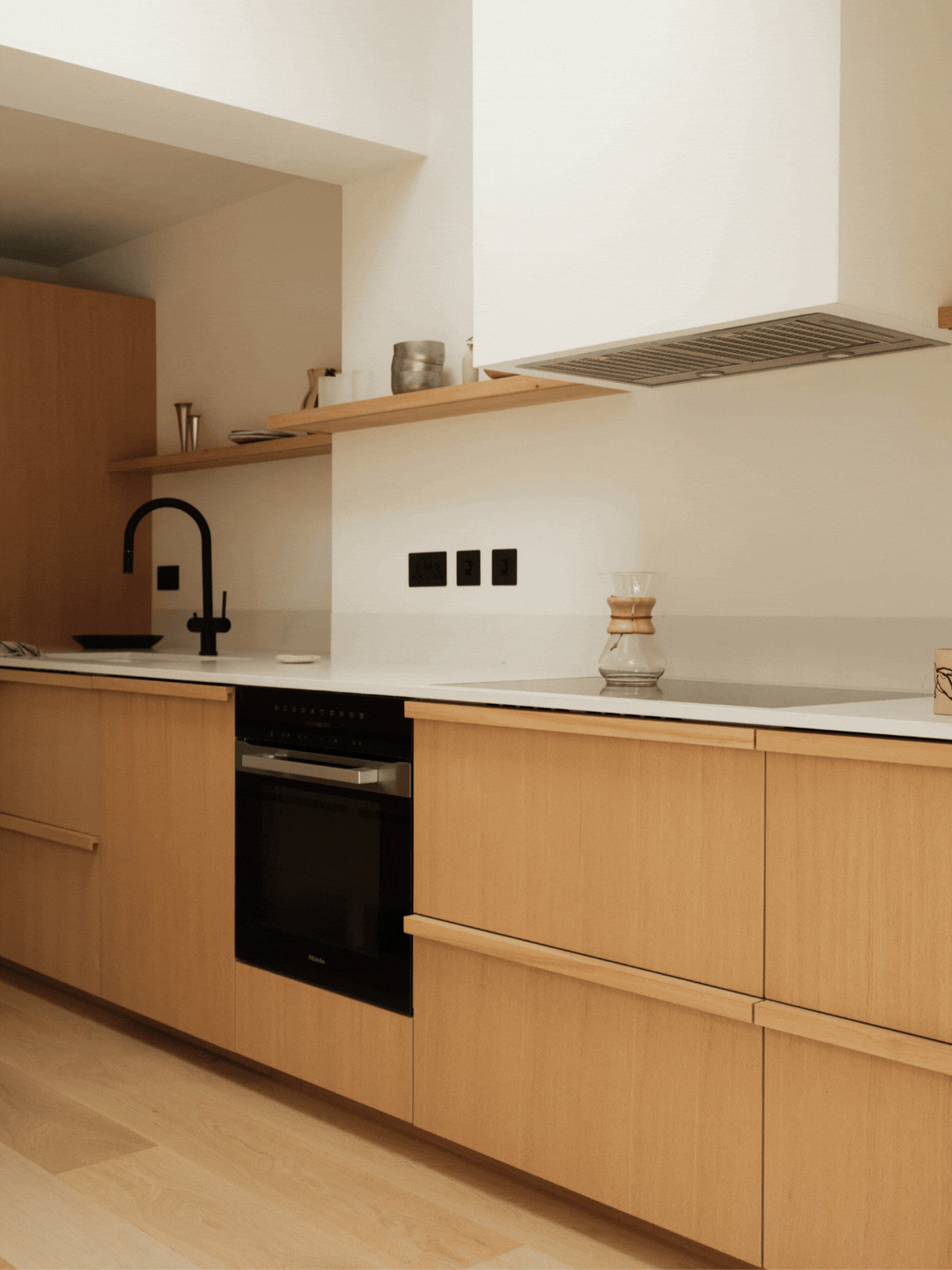 Under-hob drawer in Quarter Cut Natural Oak opening to reveal a concealed internal spice drawer in The Beckington Kitchen.