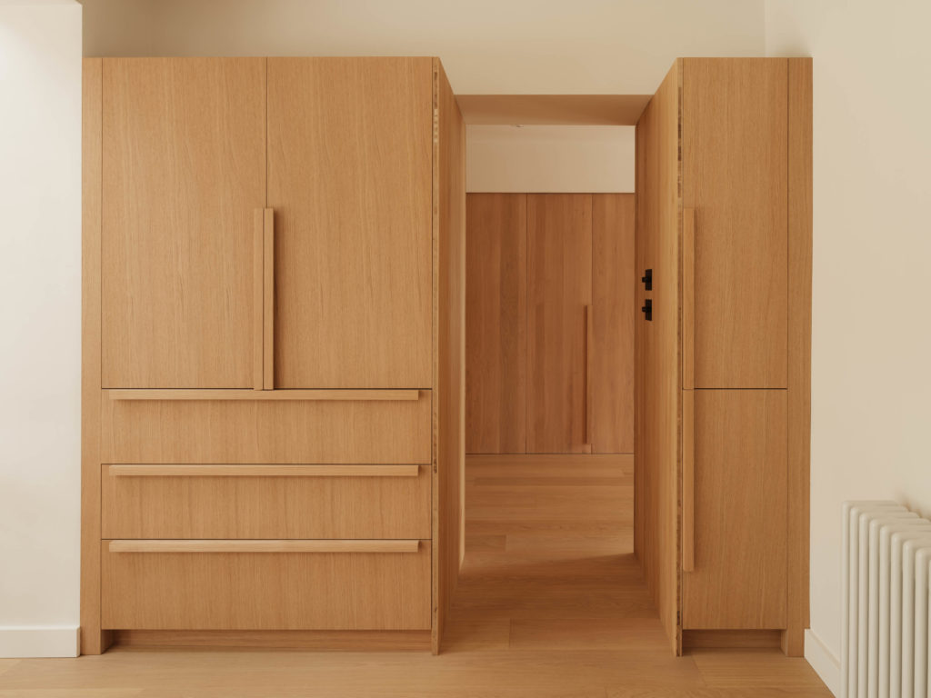 Quarter Cut Natural Oak cabinetry framing the hallway, with tall storage, drawers and matching solid oak handles.