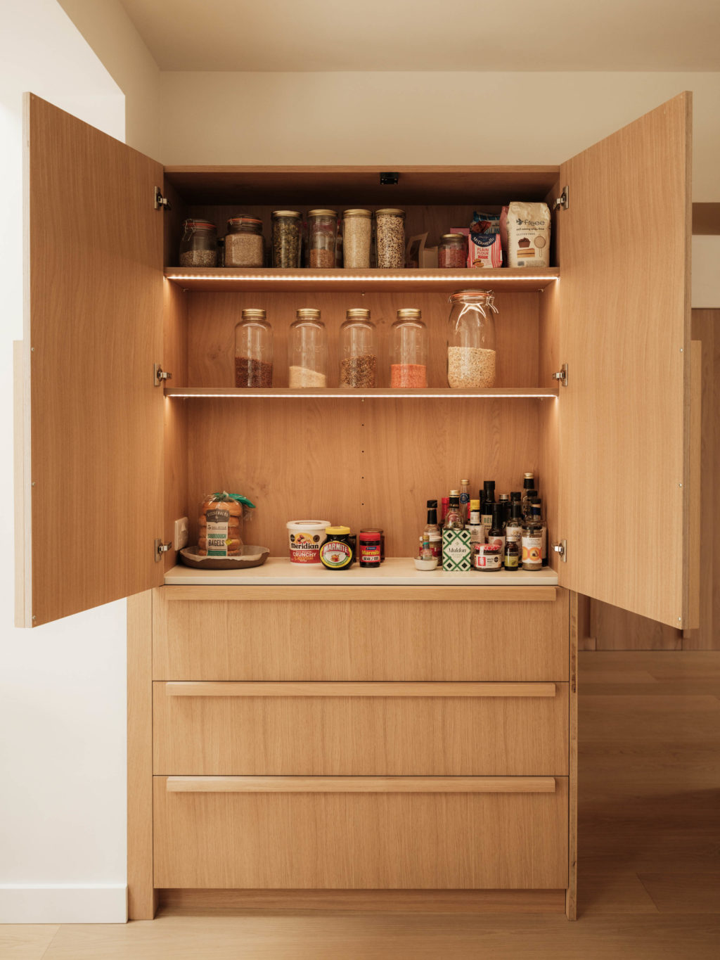 Bespoke larder in The Beckington Kitchen with Natural Oak fronts, Natural Kendal Oak internals, open shelving and deep drawers below.